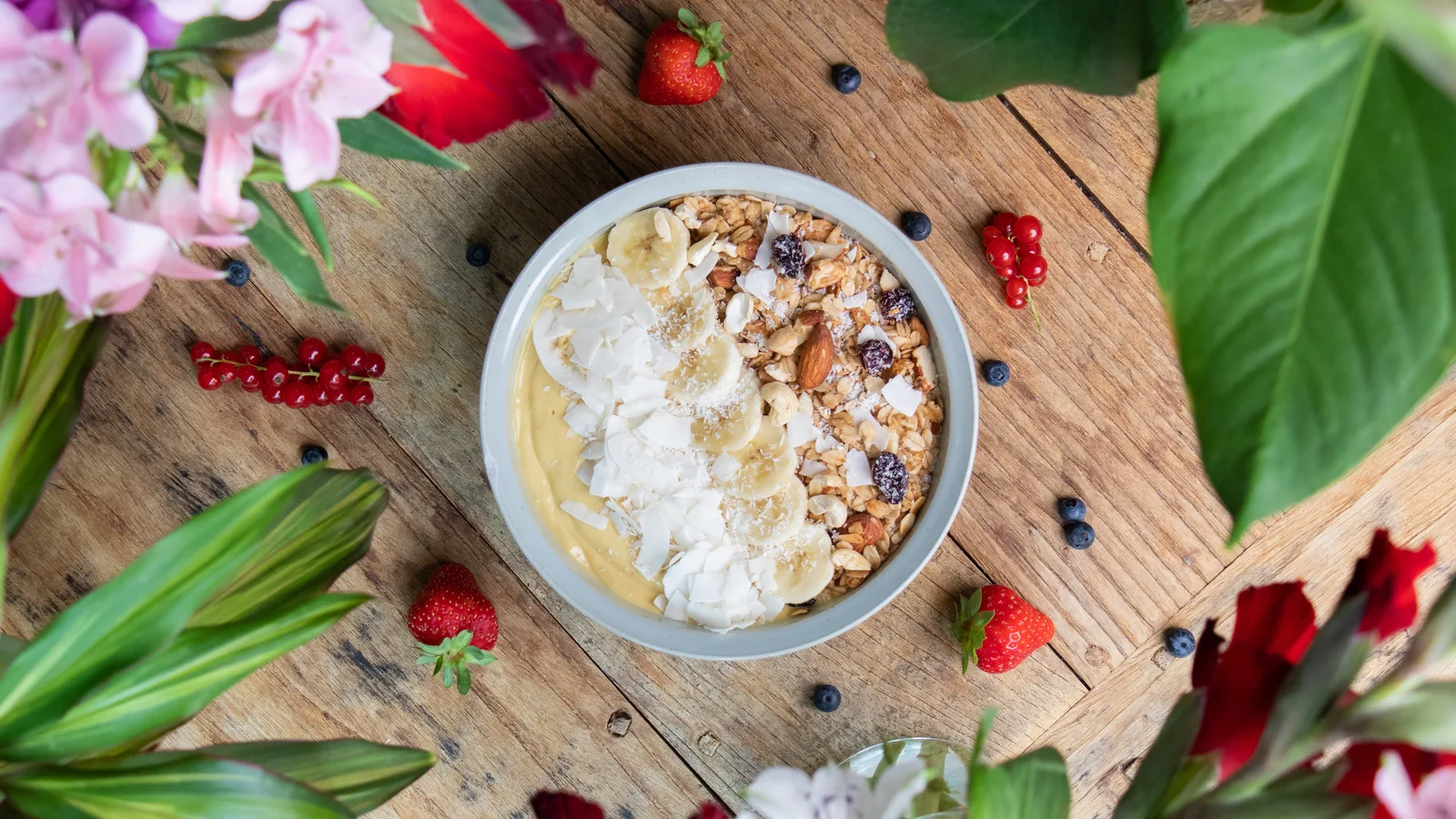 Breakfast bowl with fruit and granola photographed from above