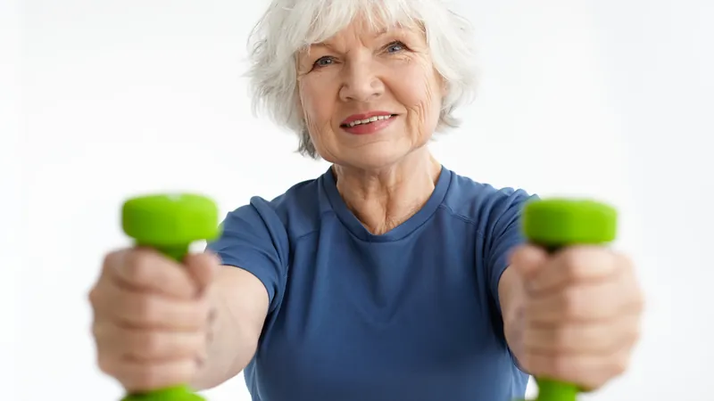 Woman in her sixties training with a pair of dumbbells