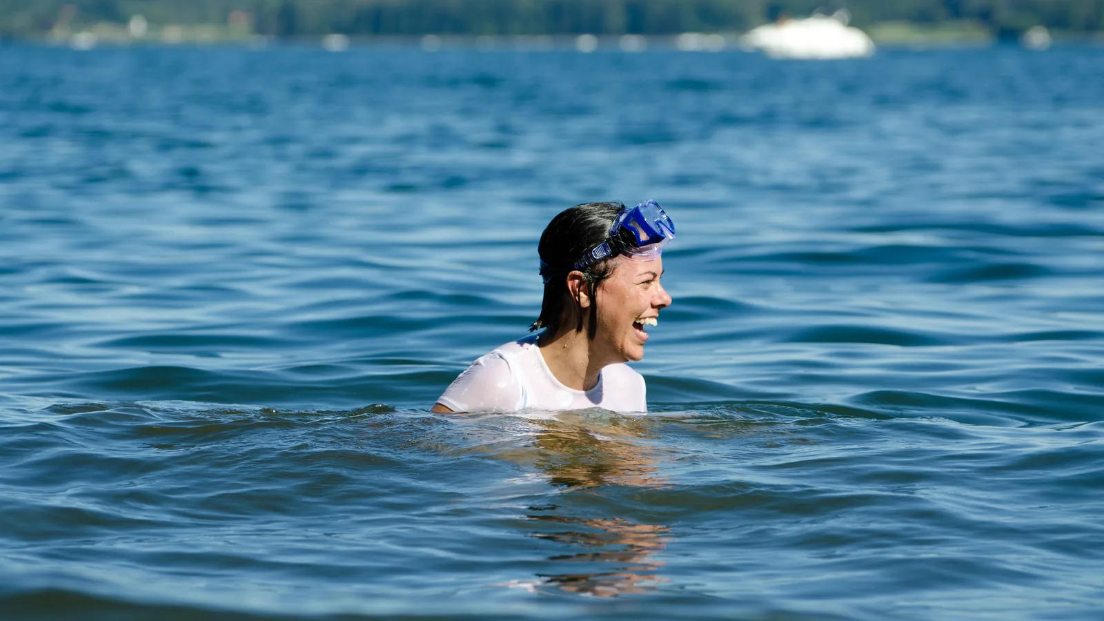 Woman swimming in the calm water of a lake